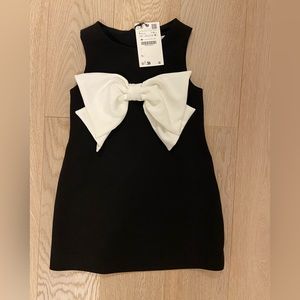 New with tags. Black dress with white bow
